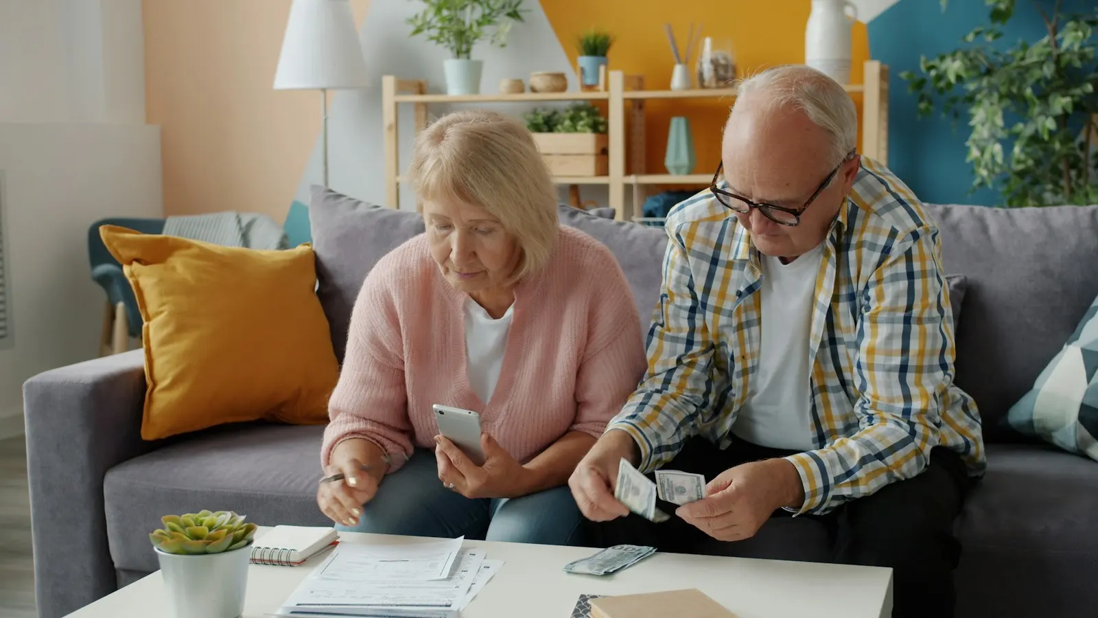 A couple reviewing household bills together at home.