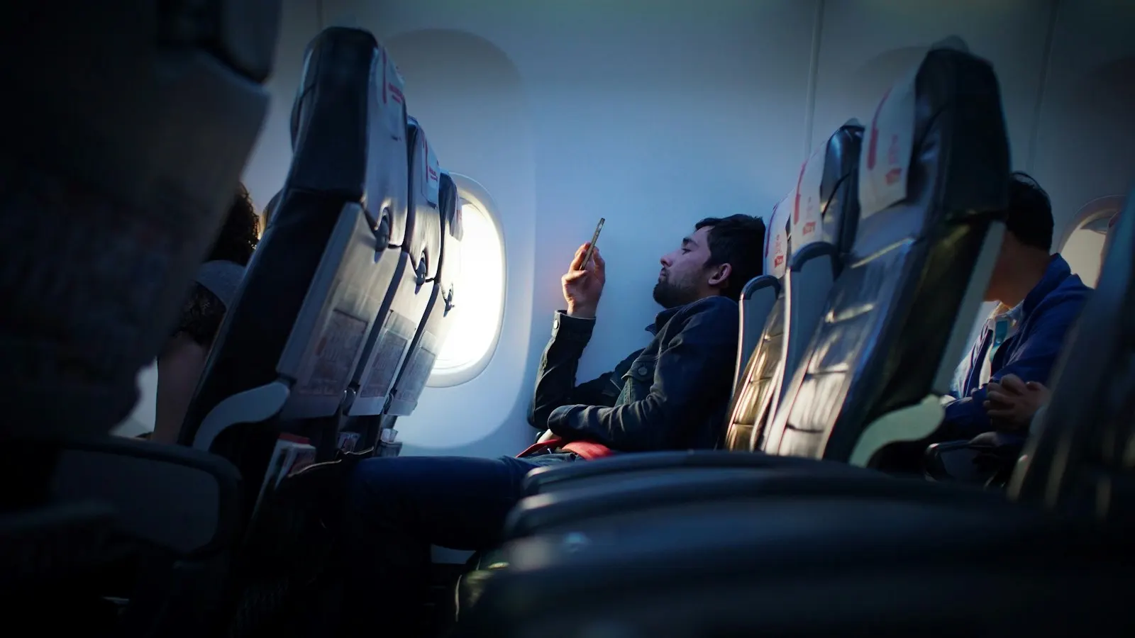 A passenger using a phone during a flight.
